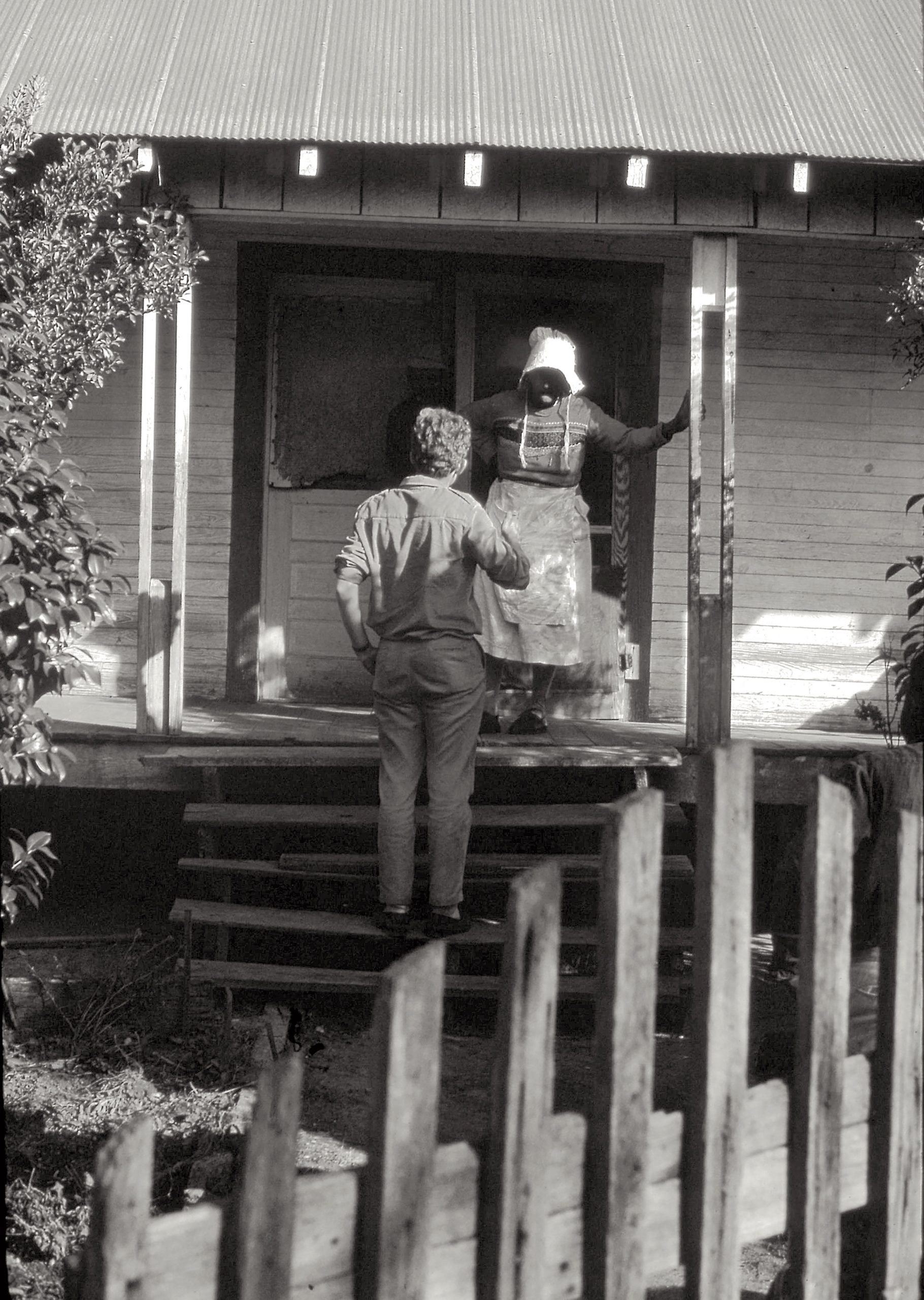 A member of Jim Lemkin’s group meets an African-American woman on her front step to discuss the Voting Rights Act of 1965 and the lifting of voter suppression tactics.